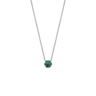 White gold pendant featuring a round emerald, suspended from a delicate gold chain. 