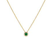 Yellow gold necklace with emerald pendant on a white background