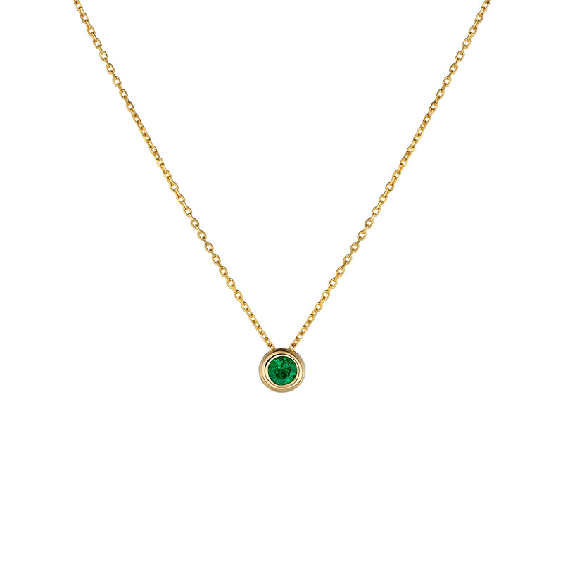 Yellow gold necklace with emerald pendant on a white background