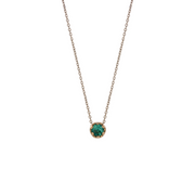 Yellow gold pendant featuring a round emerald, suspended from a delicate gold chain. 