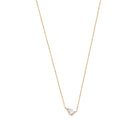 A 14k yellow gold necklace with a pear-shaped diamond centerpiece, on a white background.