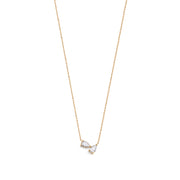 A 14k yellow gold necklace featuring two pear-shaped diamonds.