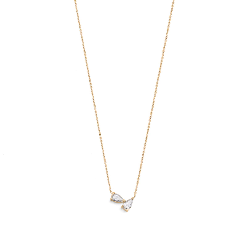 A 14k yellow gold necklace featuring two pear-shaped diamonds.
