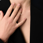 Woman wearing a minimalist necklace featuring two pear-cut diamonds set on a fine 14k yellow gold chain.