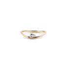 A 14k yellow gold ring with a pear-shaped diamond centerpiece.