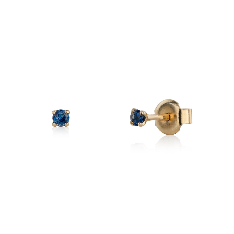 Yellow gold earrings with blue sapphires on a white background
