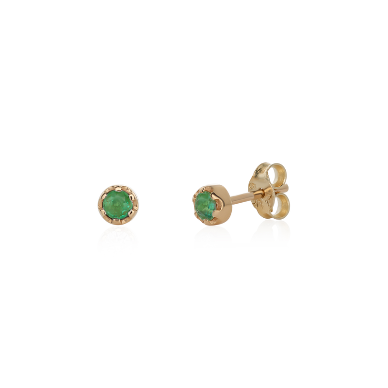 Stud earrings featuring round emeralds set in 14k yellow gold.