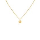 Gold necklace with a round pendant on a white background
