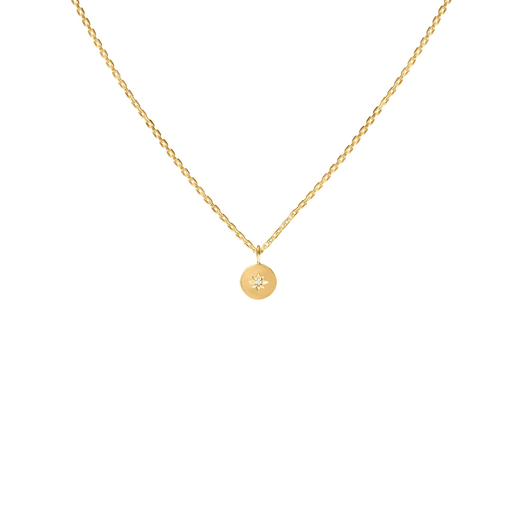 Gold necklace with a round pendant on a white background