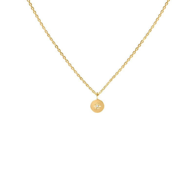 Gold necklace with a round pendant on a white background