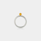 Ring with Baltic amber on a white background