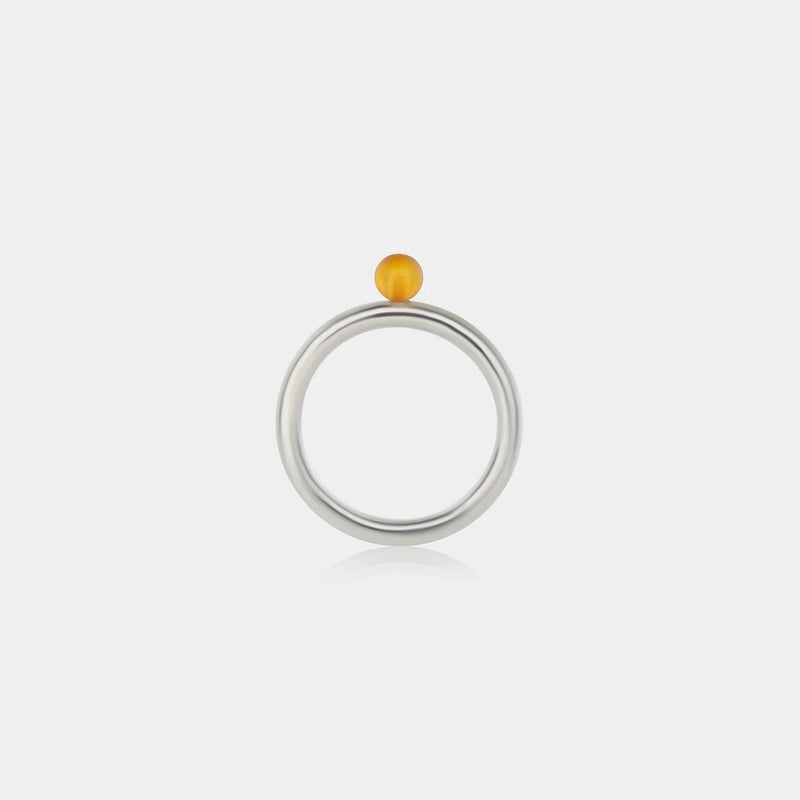 Ring with Baltic amber on a white background