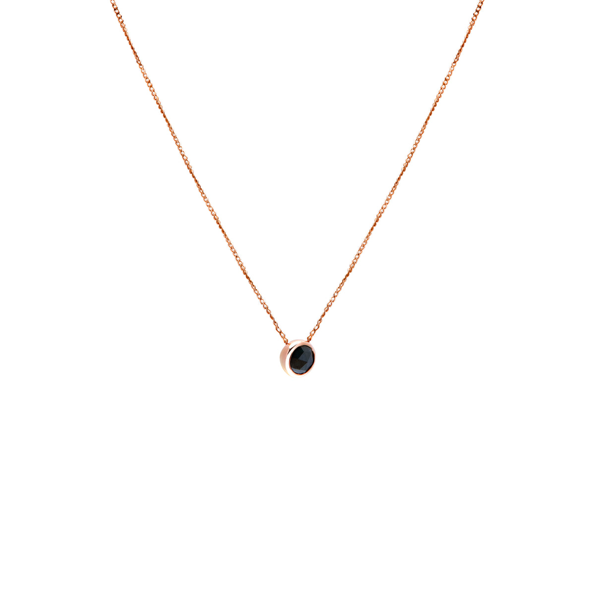 A delicate rose gold chain necklace with a small bezel-set ocean blue diamond pendant, shown against a plain white background.