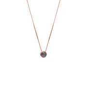 A delicate gold chain necklace with a small bezel-set rose-cut grey diamond pendant, shown against a plain white background.