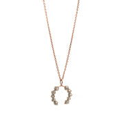 Rose gold necklace with a faceted grey diamonds pendant on a white background.
