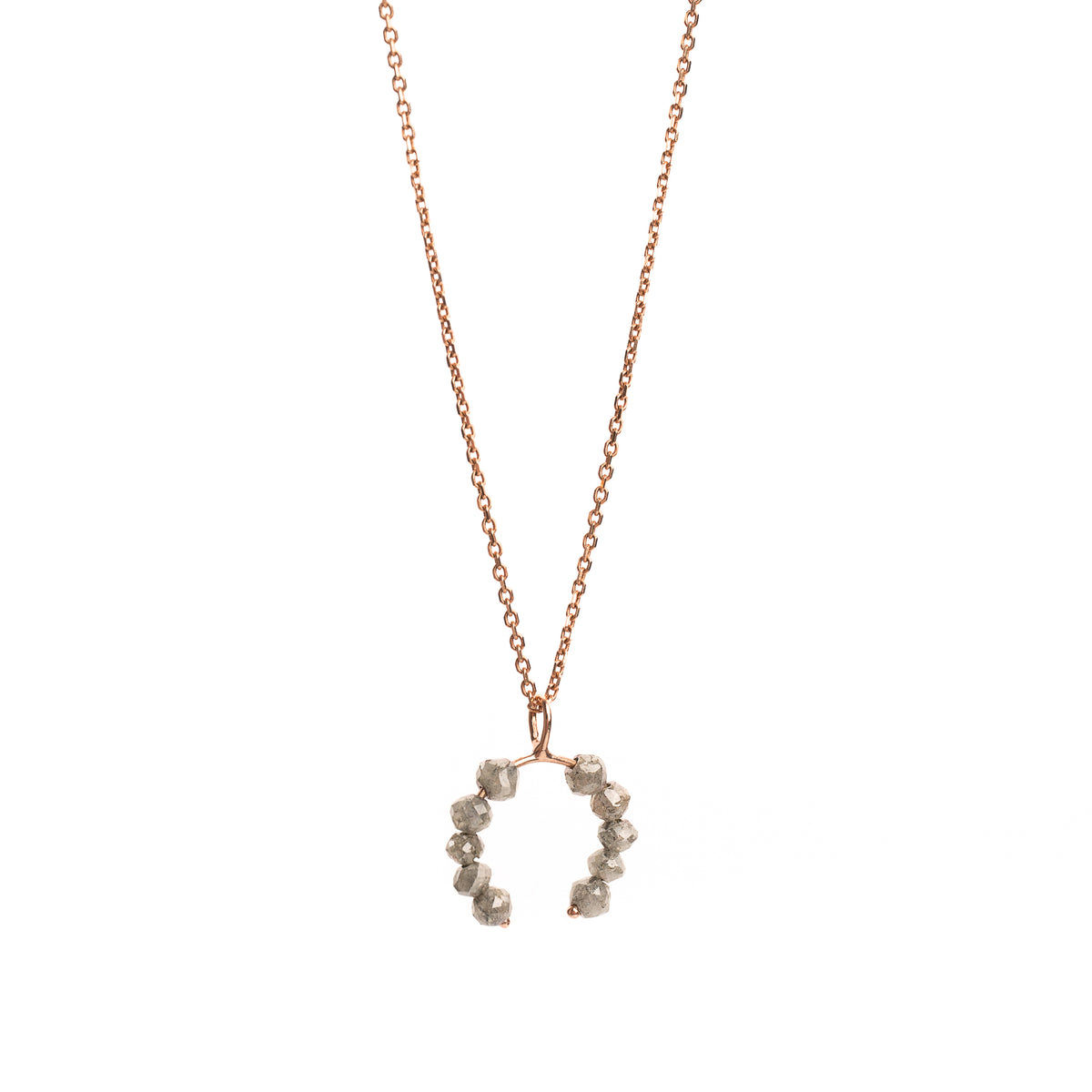 Rose gold necklace with a faceted grey diamonds pendant on a white background.