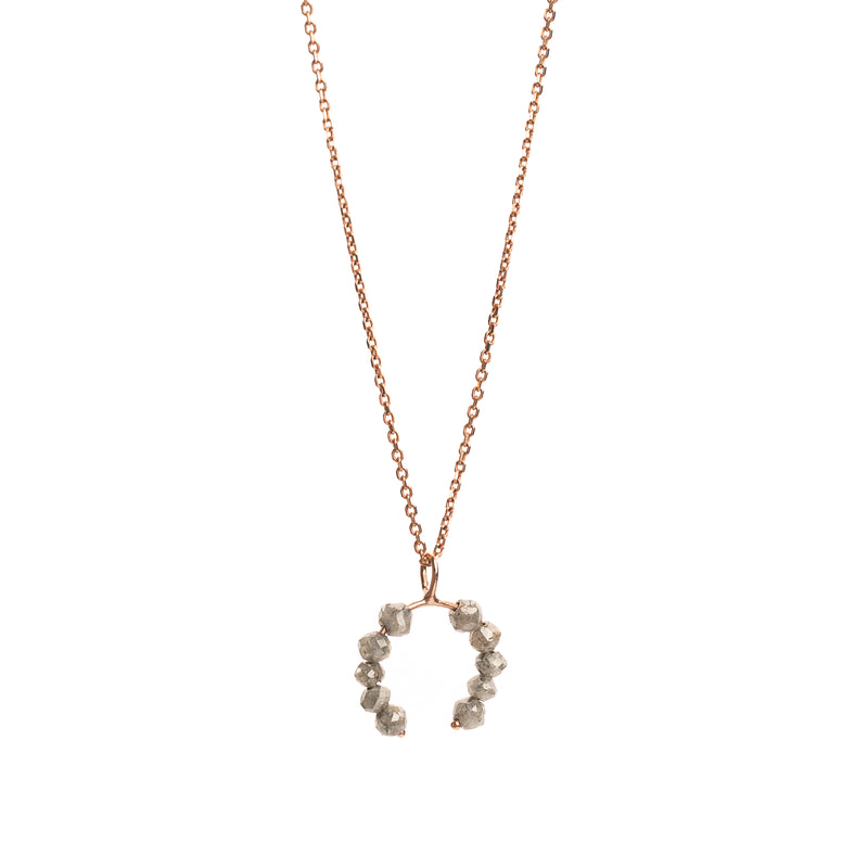 Rose gold necklace with a faceted grey diamonds pendant on a white background.