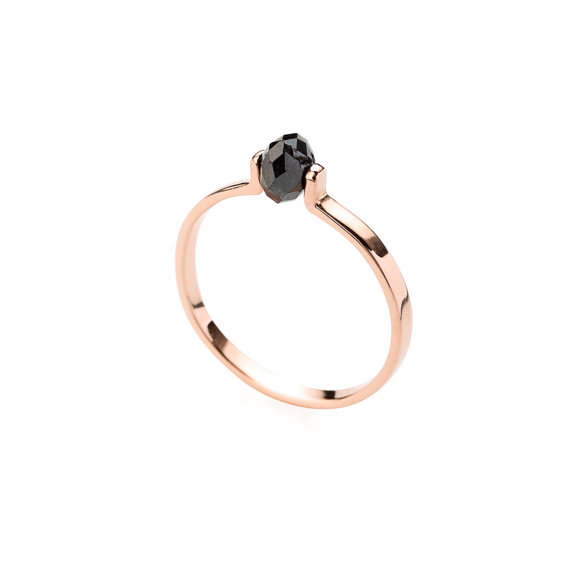 Gold ring with a black faceted diamond on a white background