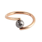 A rose gold open wrap ring featuring a faceted black diamond, shown on a plain white background.