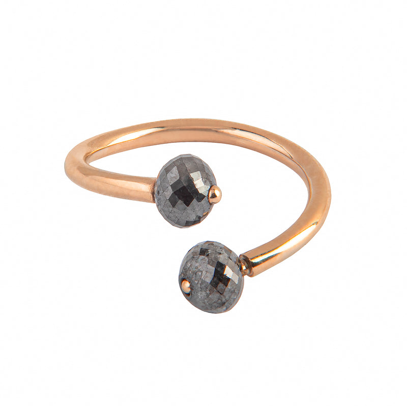 A gold open cuff ring featuring two faceted gray diamonds, photographed on a clean white background.