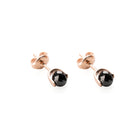 Gold earrings with black diamonds on a white background