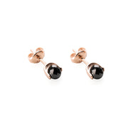 Gold earrings with black diamonds on a white background