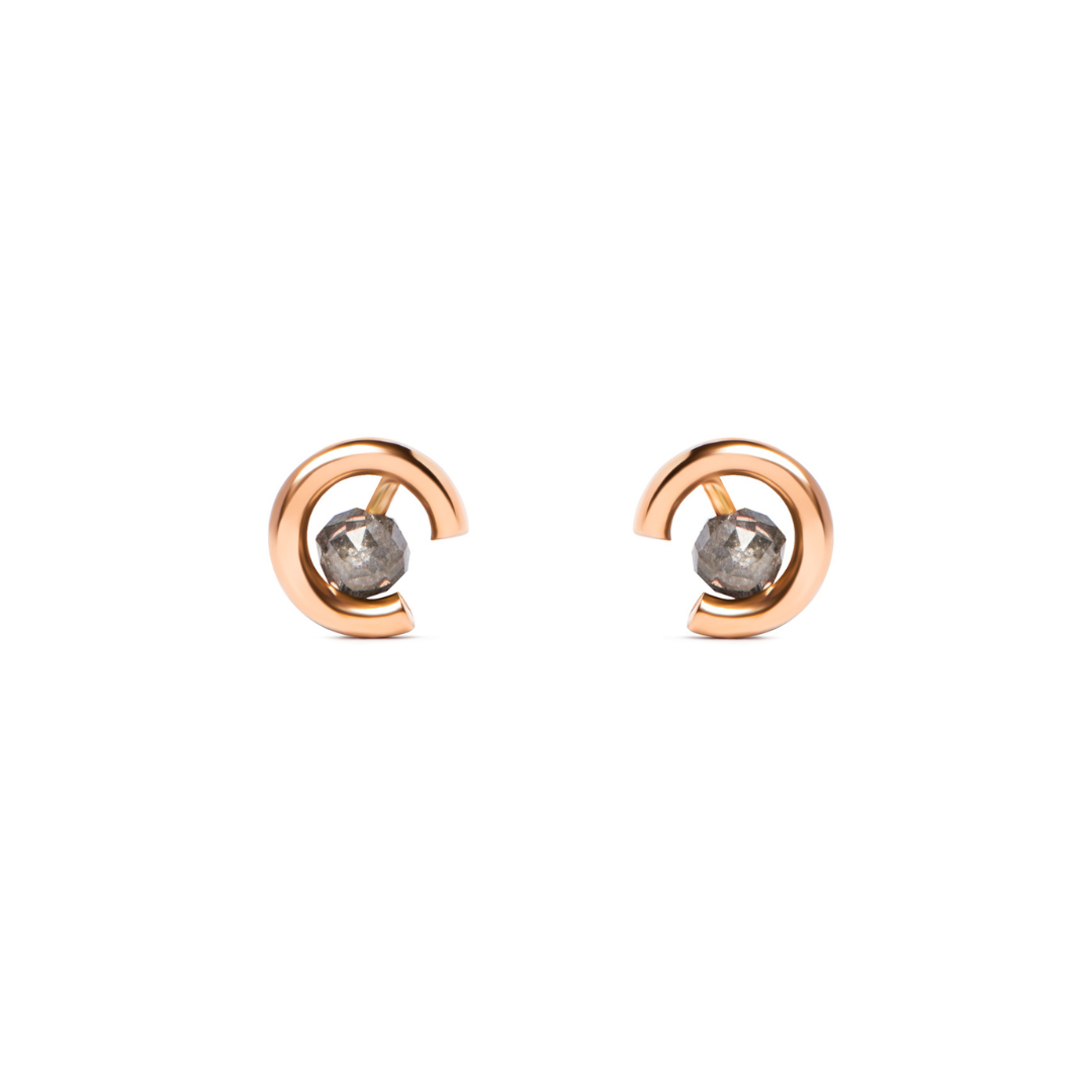 A pair of gold crescent-shaped stud earrings with round grey diamonds, shown on a plain white background.
