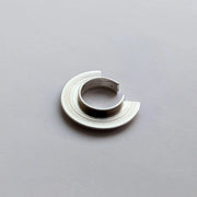 Silver ear cuff on a gray background