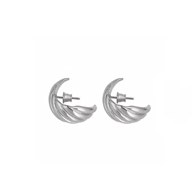A pair of silver textured, twisted silver hoop earrings, shown against a plain white background.