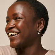 Woman with a warm smile on a beige background
