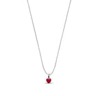 A delicate silver chain necklace featuring a small, polished red heart pendant, shown against a solid white background.