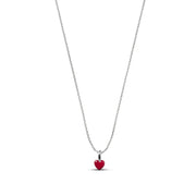 A delicate silver chain necklace featuring a small, polished red heart pendant, shown against a solid white background.