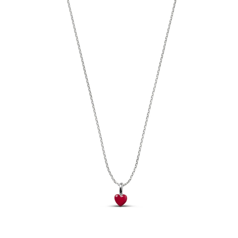 A delicate silver chain necklace featuring a small, polished red heart pendant, shown against a solid white background.