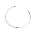 A thin, polished silver-toned metal cuff necklace with an open end, displayed on a clean white background.