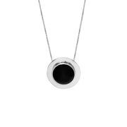 A minimalist silver pendant necklace featuring a circular silver frame with a smooth, black amber center, suspended from a delicate silver chain against a solid white background.