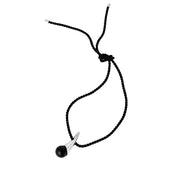 A black braided cord necklace with a silver spike pendant and a black amber spherical bead, shown on a plain white background.