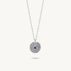 Sterling silver chain necklace featuring a round, textured disc pendant with a small blue sapphire set in the center.