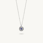 Sterling silver chain necklace featuring a round, textured disc pendant with a small blue sapphire set in the center.
