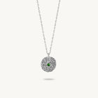 Sterling silver chain necklace featuring a round, textured disc pendant with a small emerald set in the center.