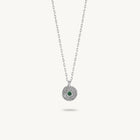 Sterling silver chain necklace featuring a round, textured disc pendant with a small emerald set in the center.