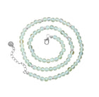 A beaded necklace made of pale mint green prehnite beads with small silver spacer beads and a silver lobster clasp, displayed on a clean white background.