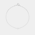 Silver bracelet with heart-shaped pendant on a light gray background