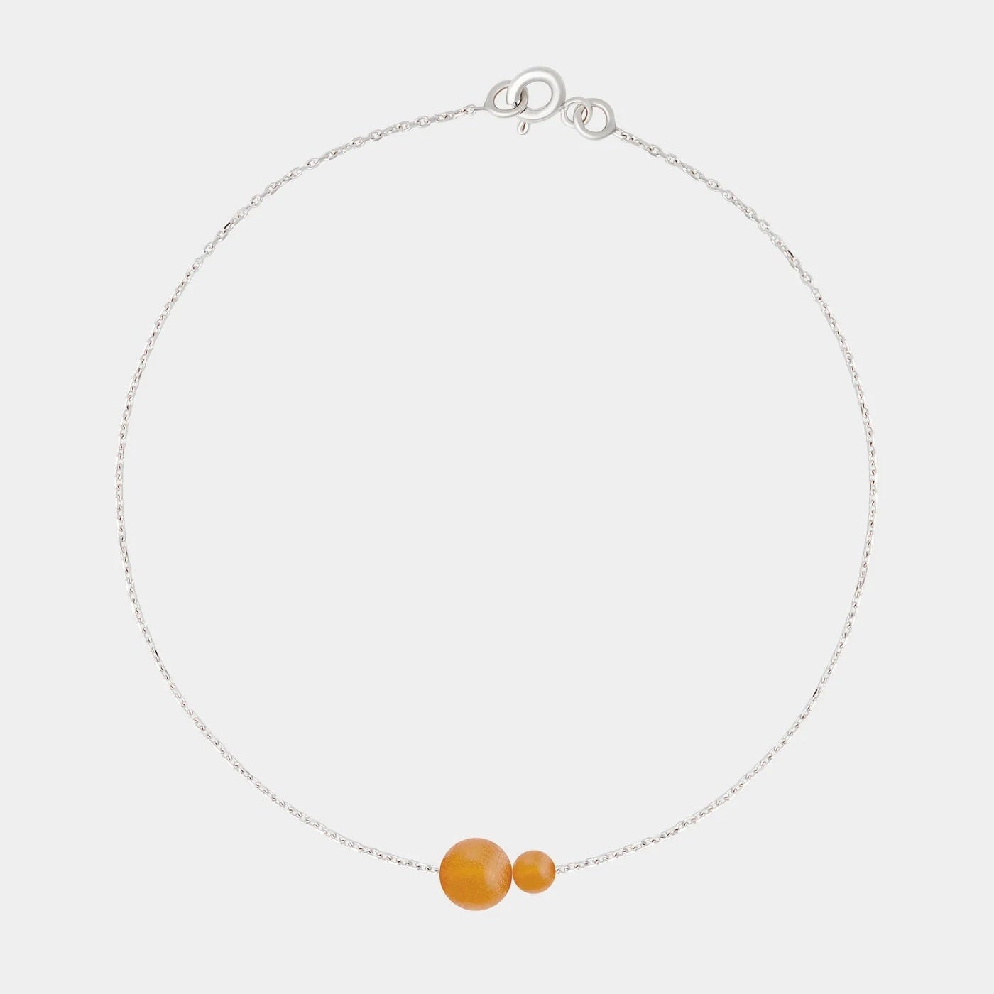 Silver bracelet with two asymmetrical Baltic ambers by Adele Notes.