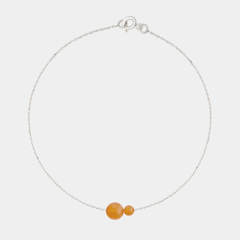 Silver bracelet with two asymmetrical Baltic ambers by Adele Notes.