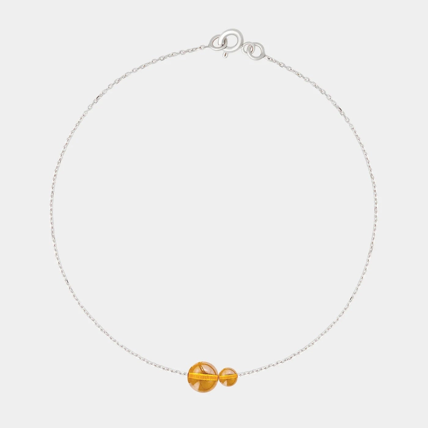 Silver bracelet with two asymmetrical Baltic ambers by Adele Notes.