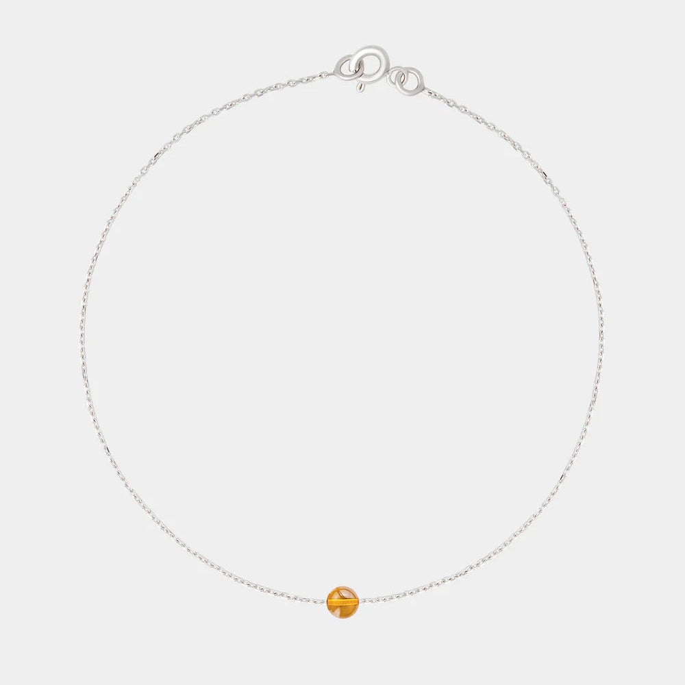 Gold bracelet with small Baltic amber by Adele Notes.
