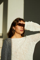 Silver earrings shaped in an organic, flowing silhouette.