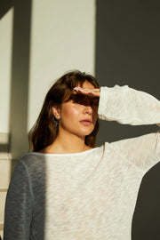Silver earrings shaped in an organic, flowing silhouette.