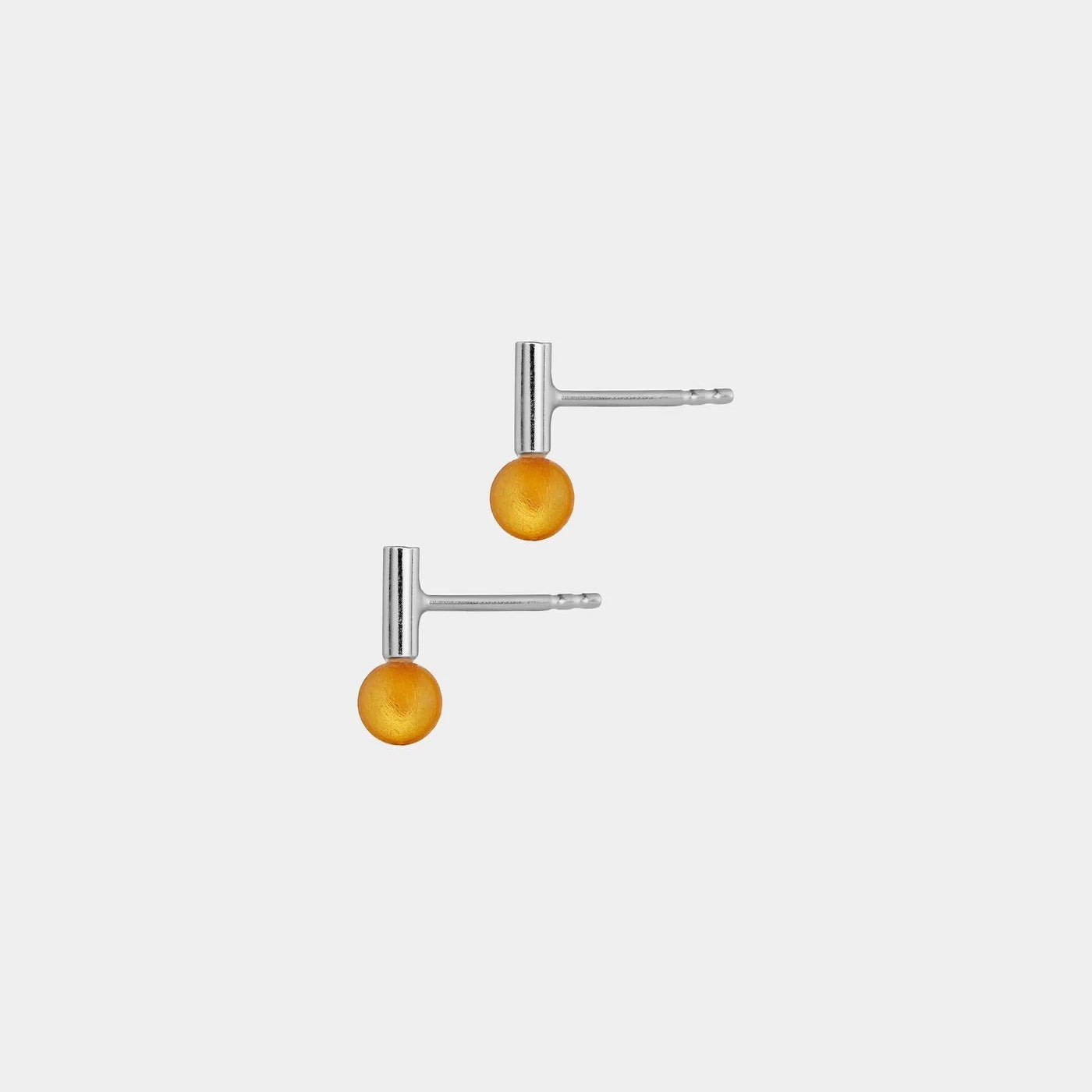 Pair of silver earrings with amber on a white background