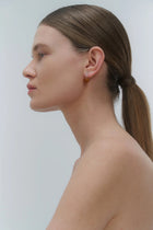 Silver earrings, featuring a structured band and a bold amber element.